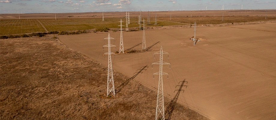 Stâlpi de înaltă tensiune pe câmp.